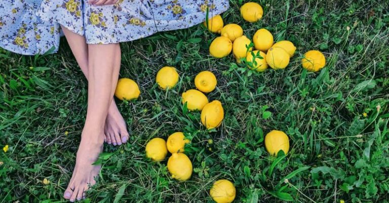 Buttonhole Foot - A woman sitting on the grass with lemons