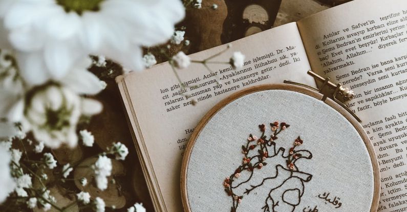 Embroidery Hoop - Embroidery Hoop Lying on a Book with White Flowers 