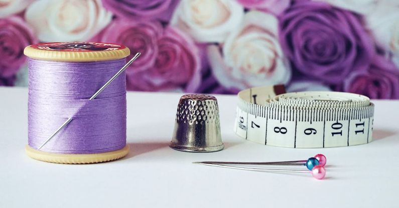 Sewing Machine - Spool of Purple Thread Near Needle Thimble and Measuring Tape
