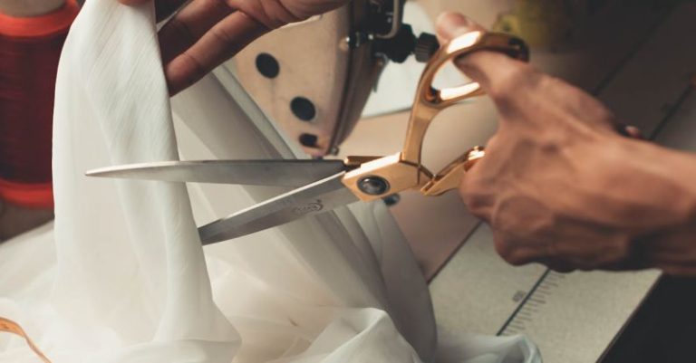 Sewing Machine - Person Cutting White Cloth