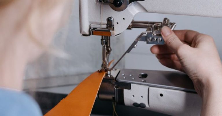 Hand Sewing - A Person Sewing a Yellow Leather Fabric